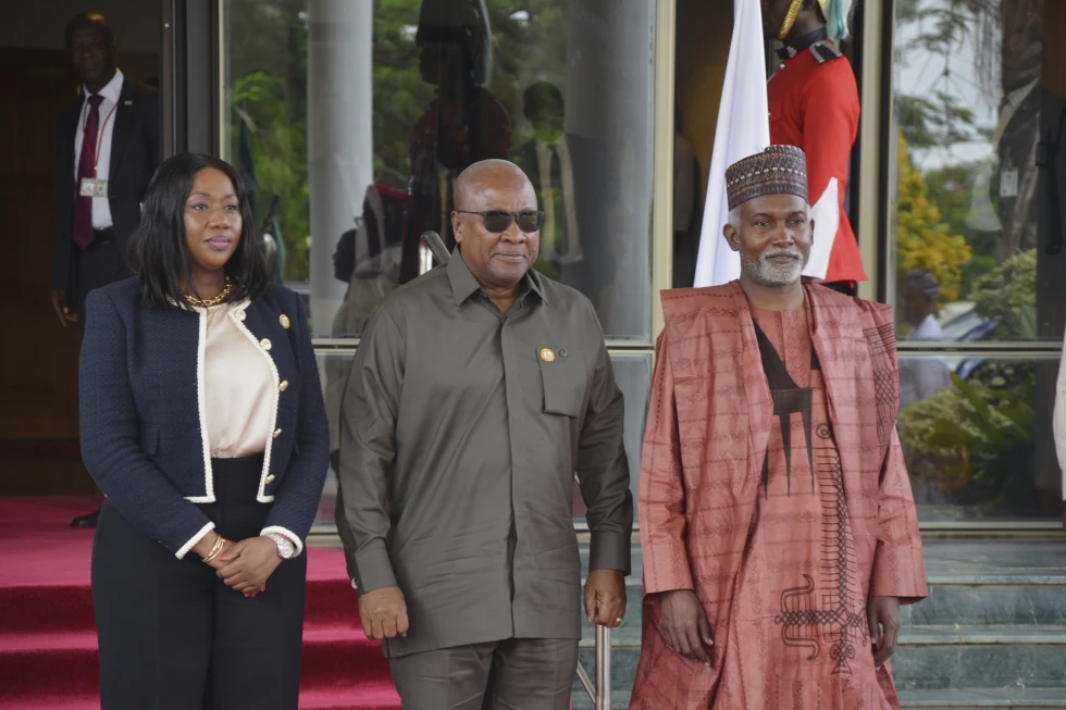Damien Larbli Tchintchibidja, Vice president of the ECOWAS Commission, left, Ghana’s President John Mahama, center and Nigeria Minister of Foreign Affairs, Yusuf Tuggar pose for a photo, prior to the start of the ECOWAS meeting in Abuja, Nigeria, Sunday, June 22, 2025. 